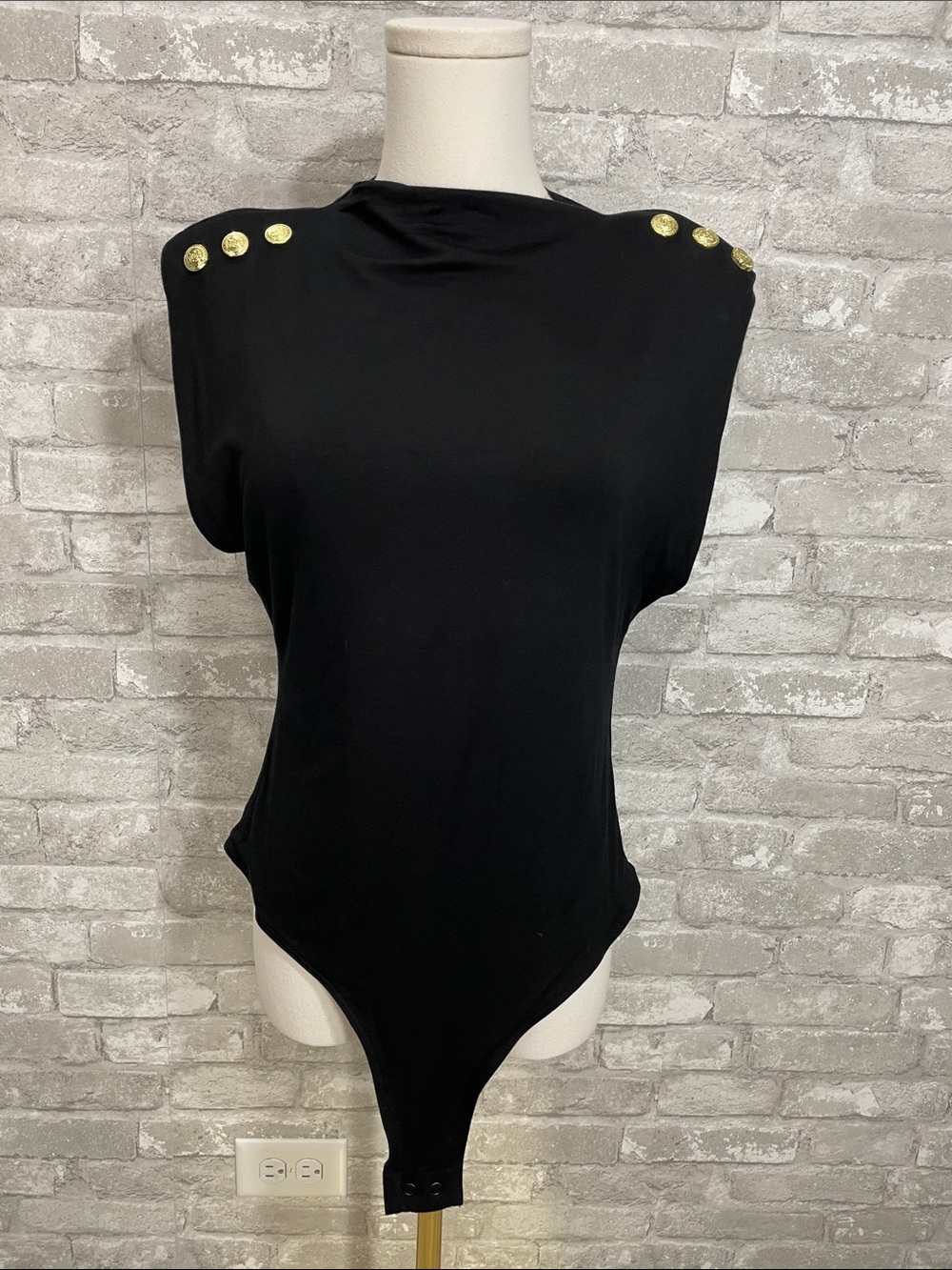 Holland Cooper Harper bodysuit features gold buttons on padded shoulders